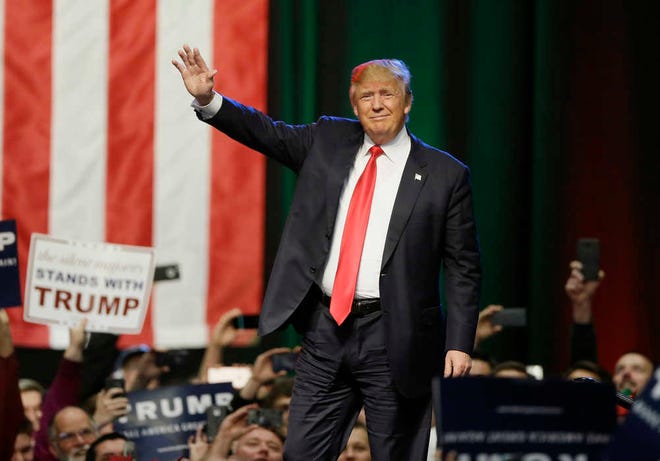 In this Dec. 21, 2015, photo, Republican presidential candidate businessman Donald Trump acknowledges the crowd before addressing supporters at a campaign rally in Grand Rapids, Mich. Months of intense focus on the Republican race, and front-runner Trump, have reverberated through the Democratic field, prompting Hillary Clinton to turn her attention to her would-be GOP challengers and leaving her chief rival, Vermont Sen. Bernie Sanders, gasping for airtime. (AP Photo/Carlos Osorio)