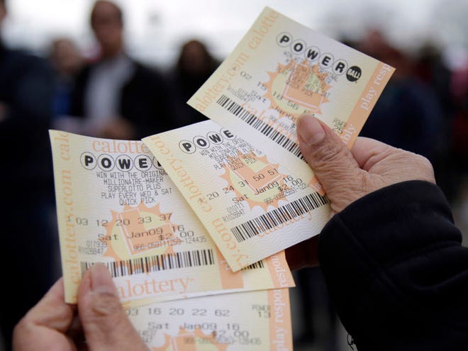 FILE - In this Jan. 9, 2016 file photo, Powerball tickets are shown in San Lorenzo, Calif. No ticket matched all six Powerball numbers following the drawing for a record jackpot of nearly $950 million, lottery officials said early Sunday, Jan. 10, boosting the expected payout for the next drawing to a whopping $1.3 billion.