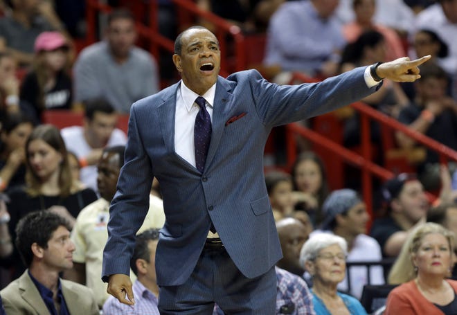 Coach Lionel Hollins calls out during the first half of a recent Nets' game against the Heat. The Nets fired Hollins and reassigned general manager Billy King amid their worst season since moving from New Jersey. The Associated Press