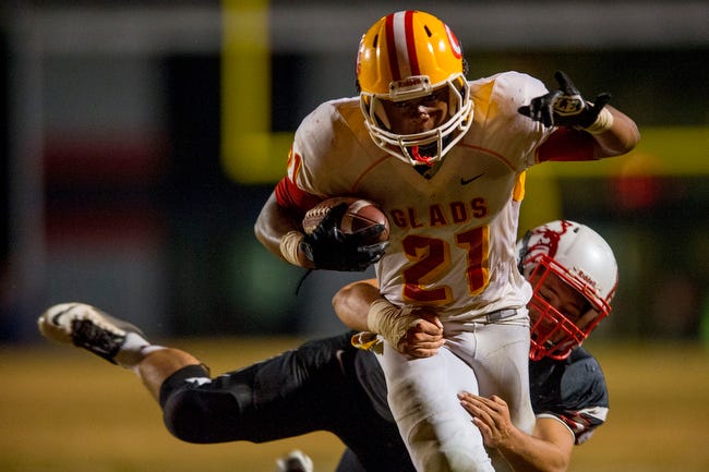 Clarke Central's Rayshawn Mccall (21) runs through a tackle during a GHSA high school football game between the Winder-Barrow Bulldogs and the Clarke Central Gladiators in Winder, Ga., on Friday, October 23, 2015. (Taylor Craig Sutton/Staff, Taylorcraigsutton.com)