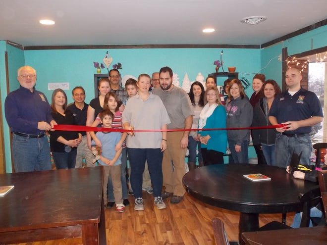 Fuller (with the scissors) is pictured above with her family and members of the Canton Area Chamber of Commerce.