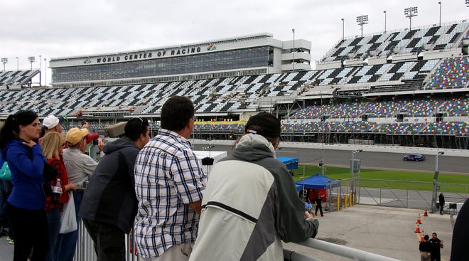 Unable to sit in the nearly finished grand stands at Daytona International Speedway (seen here in the background), race fans catch the action at the ROAR Before the 24 from the FanZone in the Speedway's infield on Friday, Jan. 8, 2016. NEWS-JOURNAL/JIM TILLER