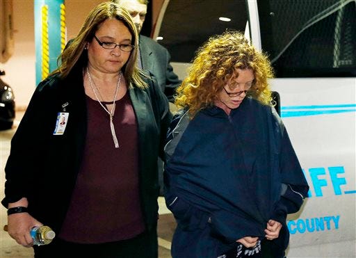 Tonya Couch, right, is escorted into Tarrant County Jail in Fort Worth on Thursday, Jan. 7. Couch, mother of a fugitive teenager known for using an "affluenza" defense in a deadly drunken-driving case, waived extradition and was sent to Texas from California to face a charge of helping her son evade capture.