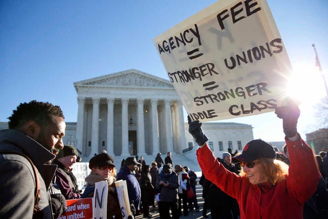 Lesa Curtis of Westchester, N.Y., right, who is pro agency fees and a former president of her union, rallies outside of the Supreme Court in Washington, Monday, Jan. 11, 2016, as the court heard arguments in the 'Friedrichs v. California Teachers Association' case. The justices were to hear arguments in a case that challenges the right of public-employee unions to collect fees from teachers, firefighters and other state and local government workers who choose not to become members. (AP Photo/Jacquelyn Martin)