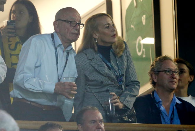 FILE - In this Nov. 1, 2015, file photo, media mogul Rupert Murdoch stands with model Jerry Hall during the Rugby World Cup final between New Zealand and Australia at Twickenham Stadium, London. Murdoch has announced his engagement to Hall, the actress and former supermodel who had a long-time relationship with Mick Jagger, Monday, Jan. 11, 2016. (AP Photo/Alastair Grant, File)