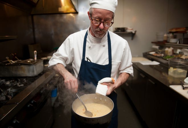 Chef Mike Odette stirs a steaming hot pot of vegetarian lentil soup.