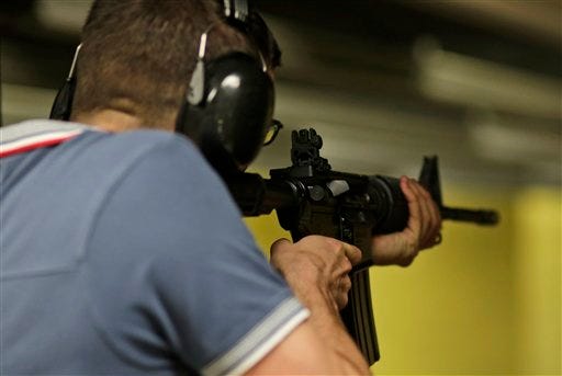 Stephen Knill-Jones, of England, fires an AR-15 rifle at the National Armory gun store and gun range, Tuesday, Jan. 5, 2016, in Pompano Beach, Fla. President Barack Obama unveiled his plan Tuesday to tighten control and enforcement of firearms in the U.S. Lincoln County Republicans will auction off an AR-15 rifle as part of a fundraiser at its Lincoln-Reagan Dinner in March. (AP Photo/Lynne Sladky)