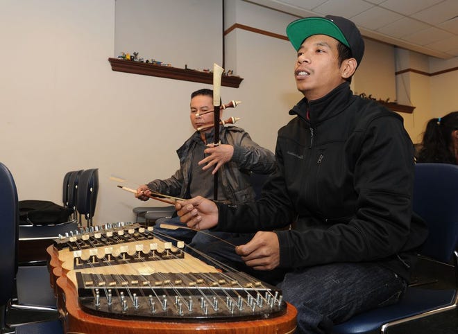 Sotha Khuth plays a tror ou, a low-tuned violin, and Phirith Thorng plays a khem, a Cambodian version of a hammer dulcimer.