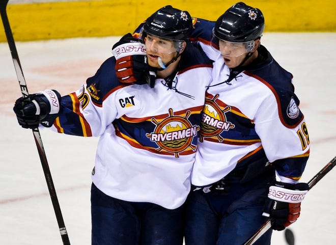 Terrence Wallin of the Rivermen gets a hug from teammate Matt Summers, right, after scoring a goal in the first period of Saturday's SPHL game with the Macon Mayhem at Carver Arena.