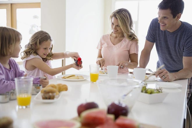 Family eating breakfast in kitchen