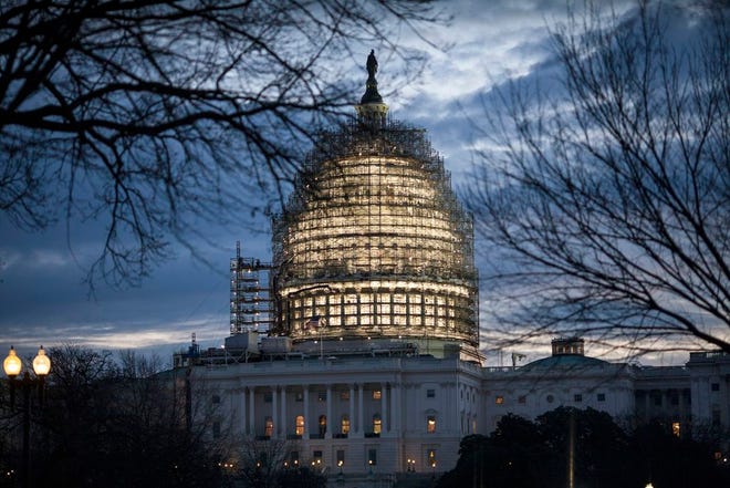 The Capitol Dome in Washington is illuminated early, Tuesday as President Barack Obama prepares to deliver his final State of the Union address before Congress.