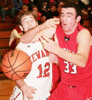 Cole Vickrey of Kewanee (12) and Levi Floming of Erie (33) scramble for a loose ball during Tuesday night’s Three Rivers Conference matchup.
