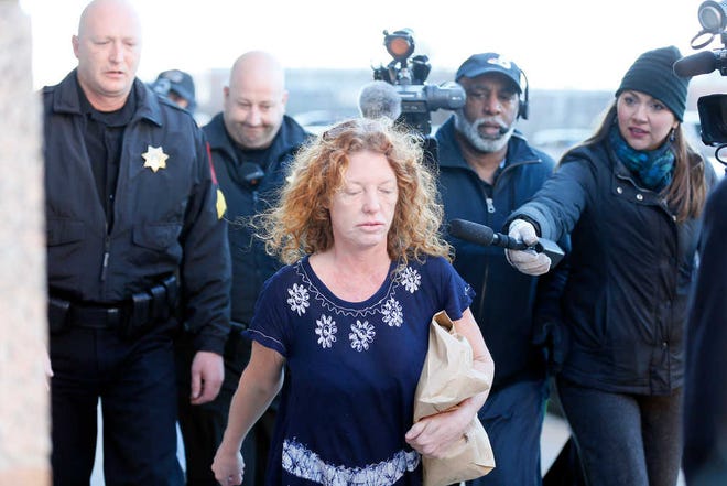 Tonya Couch, center, the mother of a Texas teen who used an "affluenza" defense in a drunken wreck, leaves Tarrant County Jail, Tuesday, Jan. 12, 2016, in Fort Worth, Texas. She is to be fitted with a GPS monitor before release. A judge decreased Couch's bond Monday from $1 million to $75,000. Couch is charged with hindering the apprehension of a felon after she and her son, Ethan Couch, were caught in a Mexican resort city. (AP Photo/Brandon Wade)