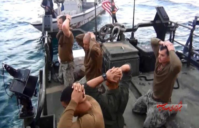 This frame grab from Tuesday, January 12, 2016 video by the Iranian state-run IRIB News Agency, shows detention of American Navy sailors by the Iranian Revolutionary Guards in the Persian Gulf, Iran. The 10 U.S. Navy sailors detained by Iran after their two small boats allegedly drifted into Iranian territorial waters around one of Iran's Persian Gulf islands a day earlier have been freed, the United States and Iran said Wednesday. (IRIB News Agency via AP)
