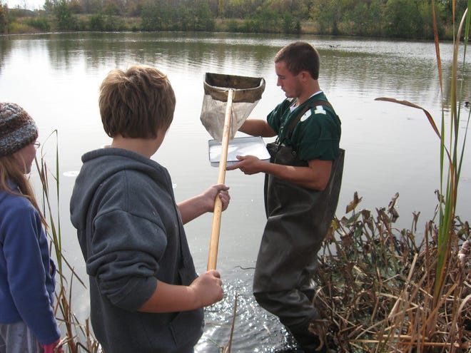 Students in Jennifer Soukhome's AP Environmental Science class at Zeeland West study the water quality of their wetland by collecting invertebrates. Contributed.