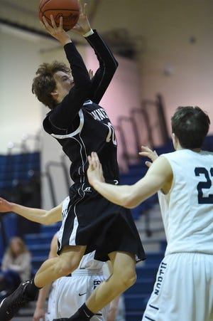 William Tennent's Brendan Carter (10) shoots over Council Rock North's Will Desautelle (22) during their game in Newtown on Thursday, Jan. 14, 2016. Council Rock North won the game 52-41.