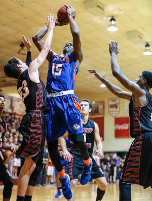Gary Lloyd McCullough For The Times-Union  Bolles' Collin Smith (15) shoots the ball over Bishop Kenny's Chris Joyce during Friday night's game.