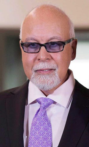 This July 26, 2013 photo shows Rene Angelil in Quebec City. Authorities say Angelil, the husband and manager of Dion, has died in Las Vegas. He was 73 and had battled throat cancer. Clark County Coroner John Fudenberg said his office was notified Thursday, Jan. 14, 2016, of Angelil's death. (Jacques Boissinot/The Canadian Press via AP)
