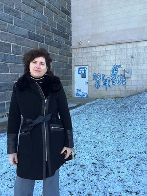 Pilgrim Hall Executive Director Donna Curtin in front of a museum wall that was recently marked with graffiti. “It’s a scar on this institution,” Curtin said.