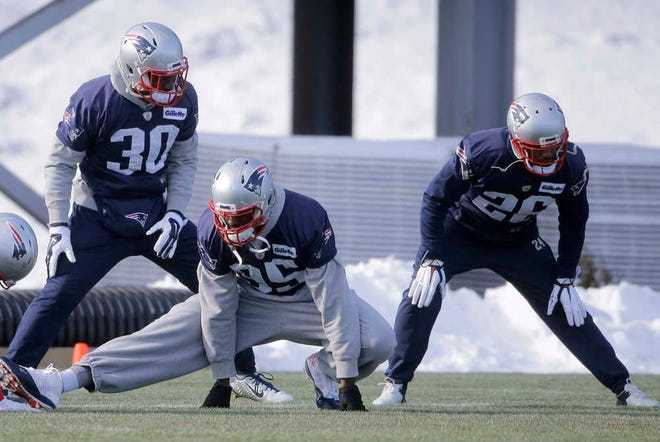 New England Patriots, front left, cornerback Duron Harmon, defensive end Chandler Jones and cornerback Logan Ryan, warm up during practice on Wednesday in Foxborough, Mass. The Patriots will host the Kansas City Chiefs today in Foxborough. (AP Photo/Steven Senne)