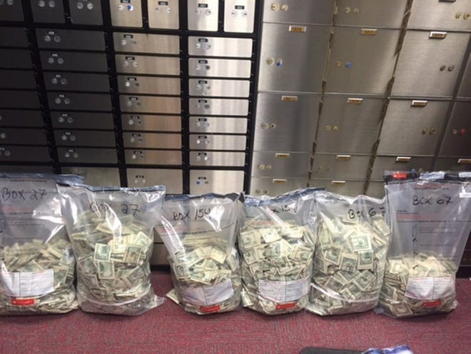 U.S. Marshals found more than $1.1 million, including this cash, last month in three safe deposit boxes at the Santander Bank branch on Union Street in downtown New Bedford. Marshals also found $382,170 in a safe deposit box at a Citizens Bank in Fairhaven. All boxes were controlled by convicted Dartmouth farmer and former lawmaker John George, Jr.

COURTESY OF U.S. ATTORNEY'S OFFICE