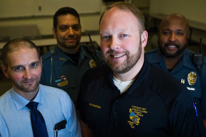 Shannon Parker from left, Jody Thompson, Al Radford and Tony Howard pose for a photo with their newly grown beards at the Athens-Clarke County police department headquarters on Wednesday, Jan. 13, 2015, in Athens, Ga. (AJ Reynolds/Staff, @ajreynoldsphoto)