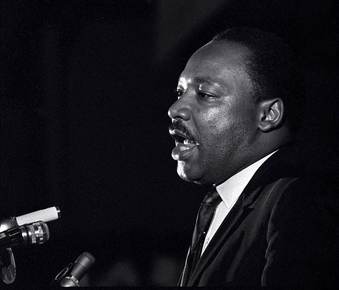 In this April 3, 1968, file photo, Dr. Martin Luther King Jr. makes his last public appearance at the Mason Temple in Memphis, Tenn. The following day King was assassinated on his motel balcony. In a new memoir, "My Life with the Kings: A Reporter's Recollections of Martin, Coretta and the Civil Rights Movement," retired Associated Press reporter Kathryn Johnson describes many civil rights flashpoints that she covered in the 1960s, and details her close relationship with the movement's leader, the Rev. Martin Luther King Jr., and his family.