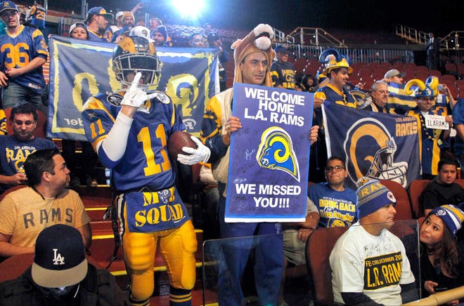 Rams fans cheer for the NFL football team at a news conference at the Forum in Inglewood, Calif., on Friday, Jan. 15, 2016. The St. Louis Rams are returning to play in 2016 in the Los Angeles area; in a few years the team will begin play at a stadium being built near the Forum. (AP Photo/Nick Ut)