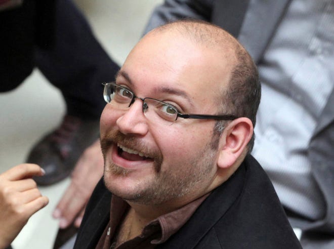 Jason Rezaian, an Iranian-American correspondent for the Washington Post, smiles as he attends a presidential campaign of President Hassan Rouhani in Tehran, Iran. Iran state television has reported that the government has released several dual-national prisoners. VAHID SALEMI /THE ASSOCIATED PRESS(2013)