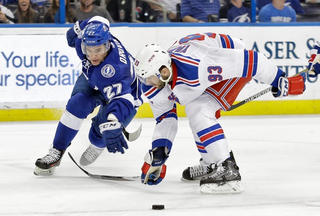 Tampa Bay Lightning left wing Jonathan Drouin, left, is knocked off the puck by New York Rangers defenseman Keith Yandle during the second period of on Dec. 30 in Tampa.