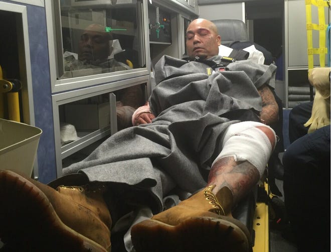 Ernesto Velazquez, a 40-year-old documented gang member, is placed in an ambulance Saturday after being taken into custody in connection with the shooting death of his girlfriend Friday and two subsequent carjackings and a kidnapping. COURTESY STOCKTON POLICE DEPARTMENT