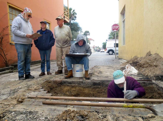 SHELDON.GARDNER@STAUGUSTINE.COM City Archeologist Carl Halbirt, left, stands with Kathy Deagan, distinguished research curator of archaeology at the Florida Museum of Natural History, as volunteer Nick McAuliffe works in the dig site on Charlotte Street Wednesday, January 13, 2016.