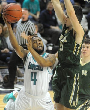 UNCW guard Jordon Talley drives to the basket past William & Mary's Oliver Tot on Saturday at Trask Coliseum in Wilmington. The Seahawks won in overtime, 97-94. Matt Born photos/StarNews