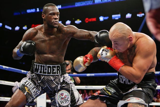 Deontay Wilder punches Artur Szpilka, of Poland, during the first round of a WBC heavyweight title boxing match Saturday, Jan. 16, 2016, in New York. (AP Photo/Frank Franklin II)