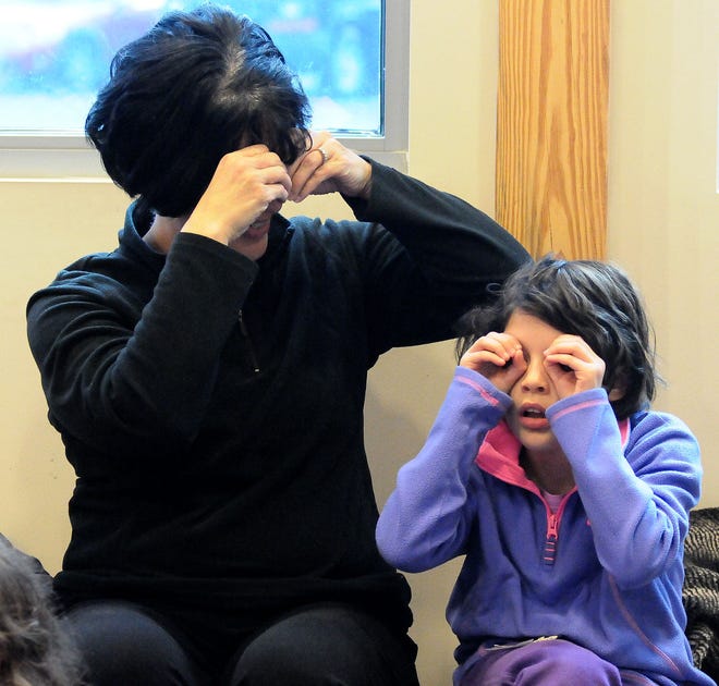Denean Montes and her daughter Maria Montes, 9, do the sign for an owl during "Sign Me A Story" at the Burlington County Library in Westampton on Saturday, Jan. 16, 2016.