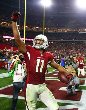 Arizona's Larry Fitzgerald celebrates after scoring the winning touchdown against Green Bay during overtime in an NFC Divisional round playoff game in Glendale, Arizona. USA TODAY SPORTS/MARK J. REBILAS