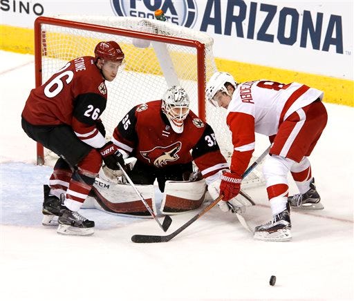 Arizona Coyotes defenseman Michael Stone (26) and goalie Louis Domingue clear the puck away from Detroit Red Wings' Justin Abdelkader (8) during the second period of an NHL hockey game Thursday, Jan. 14, 2016, in Glendale, Ariz. (Emmanuel Lozano/The Arizona Republic via AP) MARICOPA COUNTY OUT; MAGAZINES OUT; NO SALES; MANDATORY CREDIT