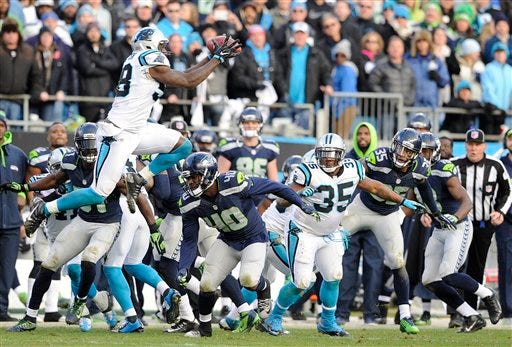 Thomas Davis leaps to catch the onside kick with 1:11 to play that clinched the Carolina Panthers' 31-24 win over Seattle on Sunday at Bank of America Stadium.