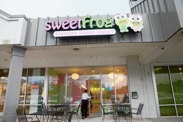 A customer enters Sweet Frog on Friday on Herritage Street. The store has reopened after closing for renovations.