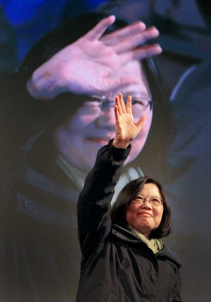 Taiwan's Democratic Progressive Party, DPP, presidential candidate, Tsai Ing-wen, raises her hands as she declares victory in the presidential election Saturday, Jan. 16, 2016, in Taipei, Taiwan. (AP Photo/Vincent Yu)