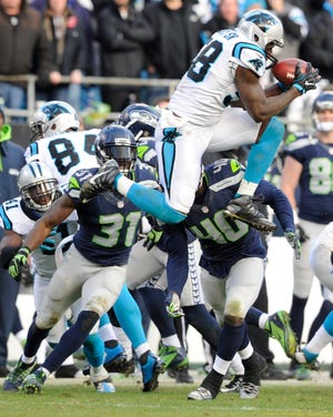 Carolina Panthers outside linebacker Thomas Davis (58) recovers an onside kick from the Seattle Seahawks to clinch their NFC division playoff game Sunday in Charlotte, N.C. The Panthers won, 31-24. Photo by AP