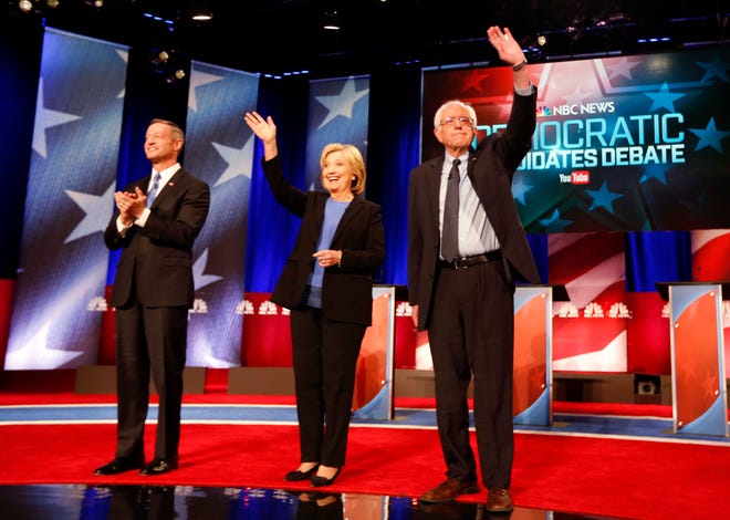 Democratic presidential candidate, former Maryland Gov. Martin O'Malley , left, Democratic presidential candidate, Hillary Clinton and Democratic presidential candidate, Sen. Bernie Sanders, I-Vt, stand together before the start of the NBC, YouTube Democratic presidential debate at the Gaillard Center, Sunday, Jan. 17, 2016, in Charleston, S.C.(AP Photo/Mic Smith)