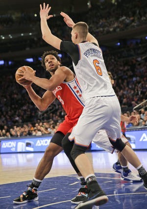 Sixers rookie Jahlil Okafor (left) is defended by the Knicks' Kristaps Porzingis during a Jan. 18 game at Madison Square Garden.
