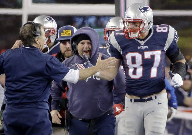 New England Patriots head coach Bill Belichick congratulates tight end Rob Gronkowski (87) after his touchdown catch against the Kansas City Chiefs in the second half of an NFL divisional playoff football game, Saturday, Jan. 16, 2016, in Foxborough, Mass.