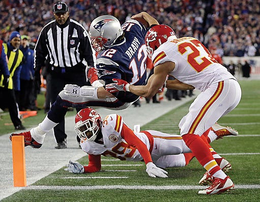 Kansas City Chiefs free safety Husain Abdullah (39) and Kansas City Chiefs defensive back Tyvon Branch (27) push New England Patriots quarterback Tom Brady out of bounds short of the goal line in the first half of a divisional playoff football game Saturday in Foxborough, Mass. The Patriots won 27-20 to advance to the AFC championship game.
