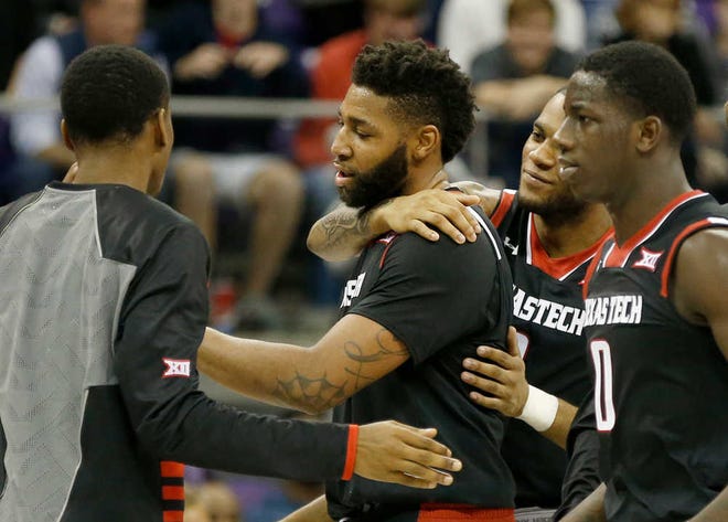 Texas Tech's Aaron Ross, center, celebrates with teammates including guard Devaugntah Williams (0) during their game against TCU on Monday, Jan. 18, in Fort Worth.