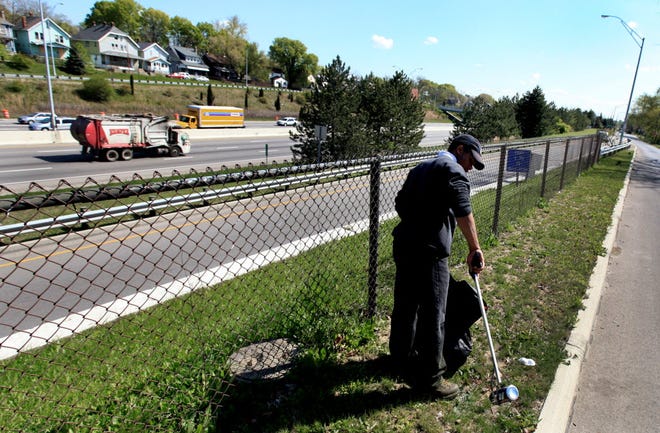 Consider taking a walk in your neighborhood to clean up litter. AP Photo, file / The Columbus Dispatch, Fred Squillante