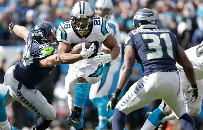 Carolina Panthers running back Jonathan Stewart runs against Seattle Seahawks strong safety Kam Chancellor during the first half of an NFL divisional playoff game on Sunday in Charlotte, N.C. (AP Photo/Bob Leverone)