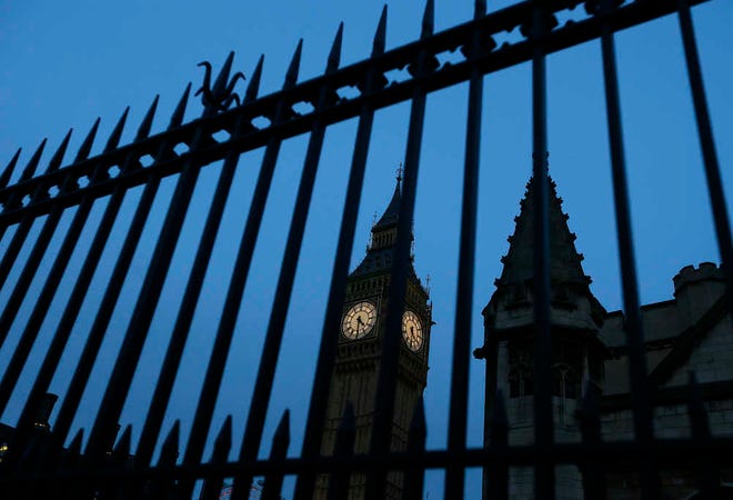 Big Ben in the Elizabeth Tower is seen through railings, at Britain's Parliament buildings in Westminster in London, Monday, Jan. 18, 2016. A proposal to ban Donald Trump from the United Kingdom because of his comment to ban Muslims from entering the United States drew a lively debate Monday in the British Parliament. (AP Photo/Kirsty Wigglesworth)