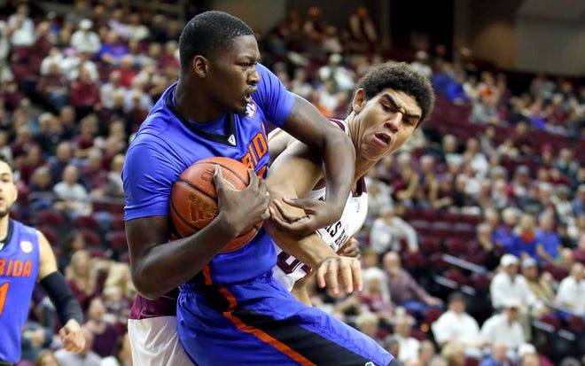 Florida's Dorian Finney-Smith fights for a rebound with Texas A&M's Tyler Davis during the first half on Jan. 12 in College Station, Texas. (AP Photo/Sam Craft)